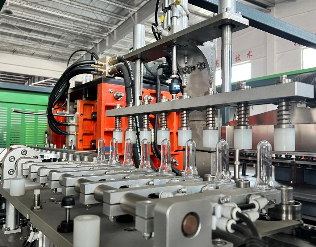 A Close-Up Of A Pet Preform Neck And A Bottle Blowing Machine Spindle
