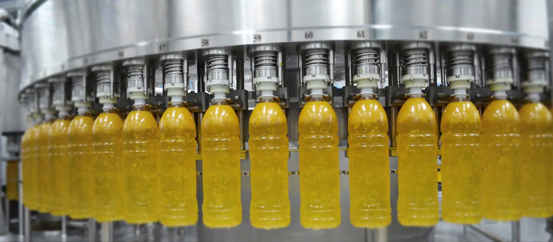 A Bottle Being Filled With A Hot Liquid In A Factory Setting.