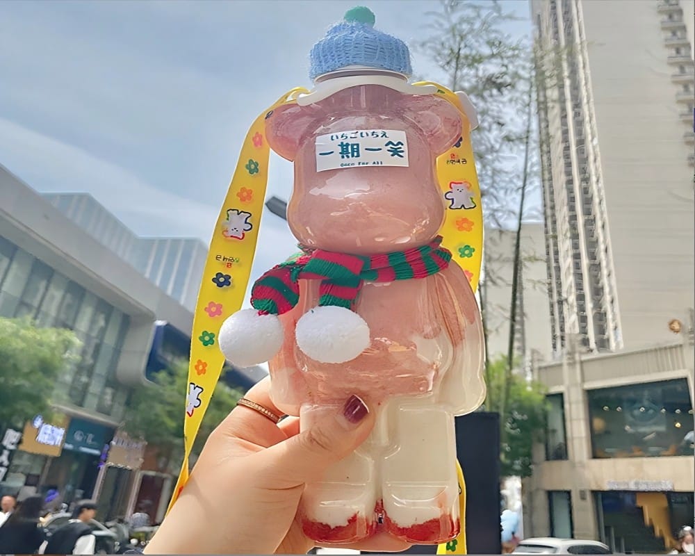 A Person Taking A Photo Of A Bearbrick Bottle For Social Media