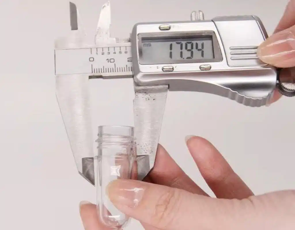 A Close-Up Of A High-Quality Pet Preform Being Measured With Calipers.