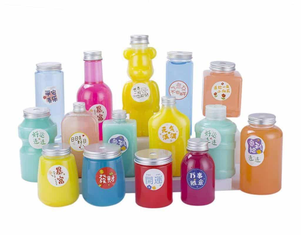Three Bottles Showcasing The Design Trends: A Bear-Shaped Bottle, A Mini Water-Cooler-Jug Bottle, And A Bottle Co-Branded With A Cartoon Character.